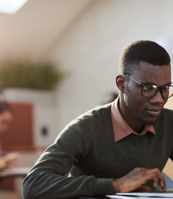 African Student Working in Cafe