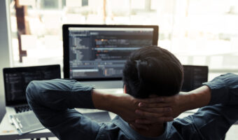 Asian programmers man are relaxing and looking at the code on th