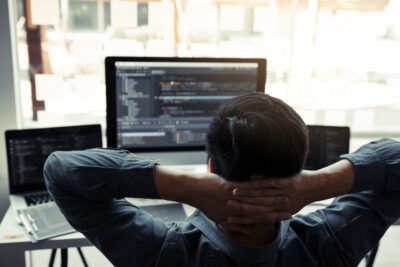 Asian programmers man are relaxing and looking at the code on th