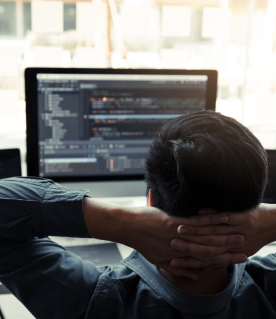 Asian programmers man are relaxing and looking at the code on th