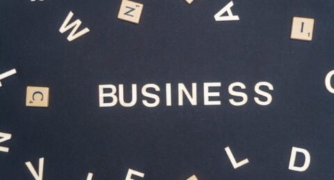 BUSINESS word written on dark paper background. BUSINESS text for your concepts