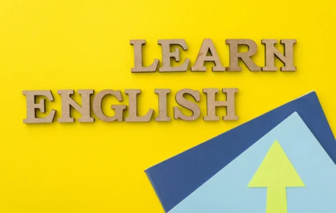 Learn English, words in wooden letters with yellow background